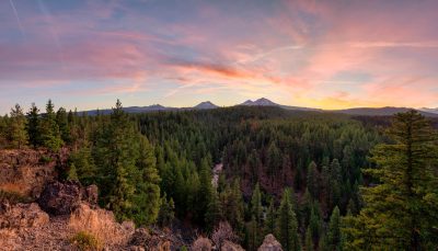 The autumn sun sets over Three Sisters in the Cascade Mountains from Bend, Oregon