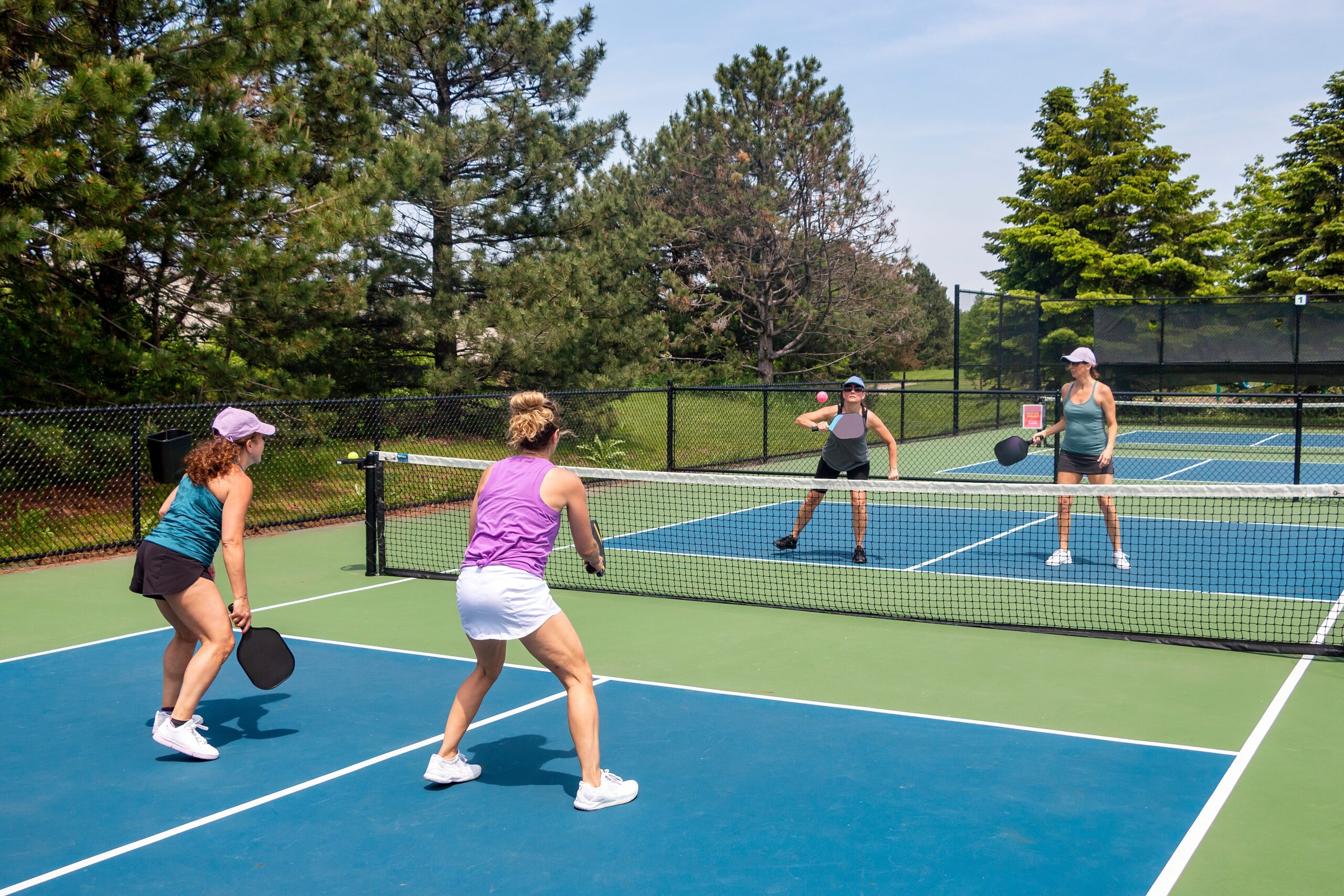 A,Competitive,Doubles,Game,Of,Pickleball,At,The,Net,On